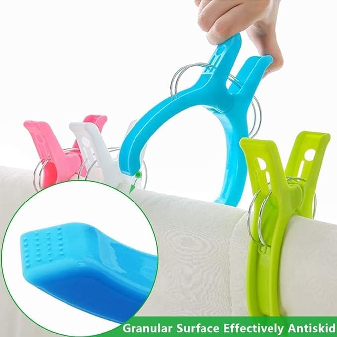 Turquoise 7AGAT XL plastic clothespin on white fabric, showcasing heavy-duty beach towel clip with anti-slip textured surface.