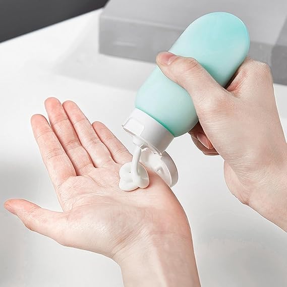 Set of three 60ml refillable travel bottles by 7AGAT for toiletries, made of durable squeeze containers for convenient skin care travel.