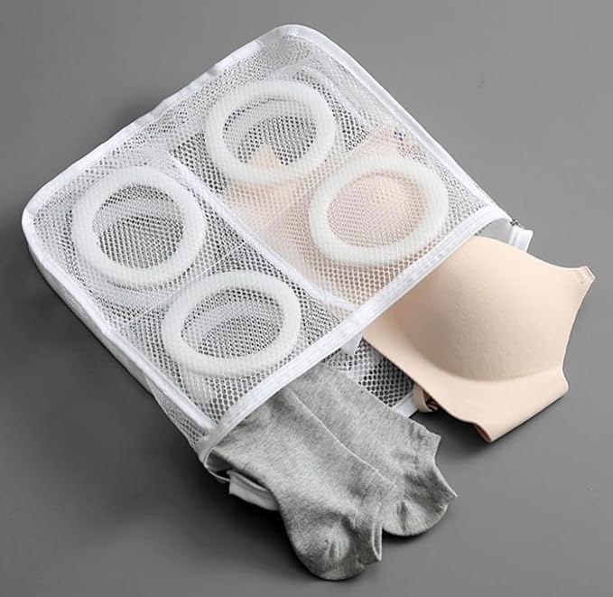 White mesh laundry bag for shoes with zipper closure and straps, protects shoes and washing machine during laundry.