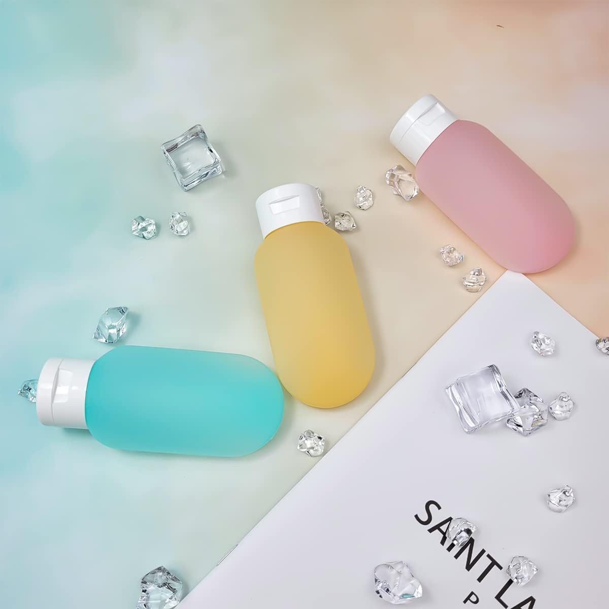 Set of three 60ml refillable travel bottles from 7AGAT, squeeze containers for toiletries, ideal for skincare and travel.