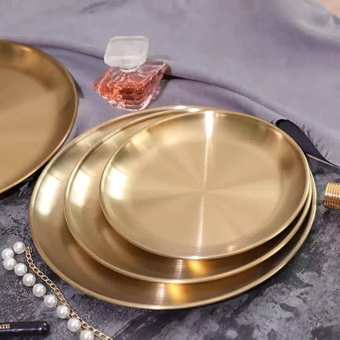 Set of three gold stainless steel round serving plates in different sizes, ideal for salads, desserts, and outdoor dining.