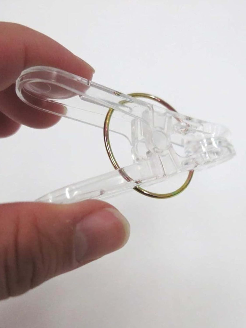 Set of 24 clear plastic clothespins with metal hanging rings, ideal for laundry, photos, and crafts by 7AGAT.