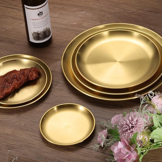 Set of three gold stainless steel round serving plates in different sizes, ideal for kitchen, restaurant, or outdoor dining.