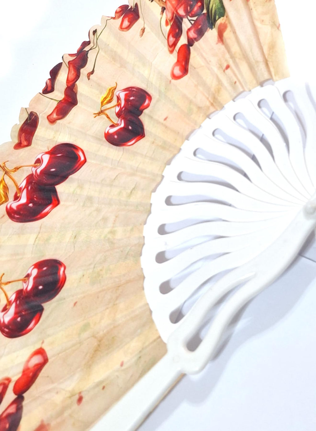 Colorful plastic folding hand fan with wavy handle by 7AGAT, featuring vibrant prints and a compact design for summer use.