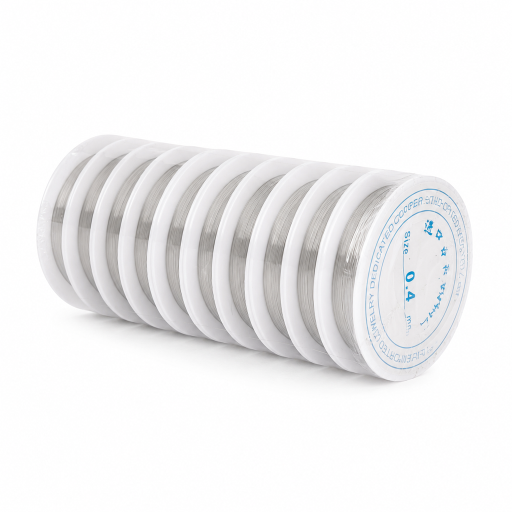 A stack of white spools of silver-colored wire, with the front spool showing a blue label that reads 'SIZE 0.4 MM' and 'TANAMA'.