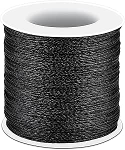 Spool of black thread on a white background