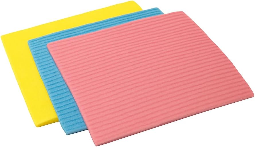 Three rectangular textured mats or pads in yellow, blue, and pink, arranged in a staggered stack on a plain white background.