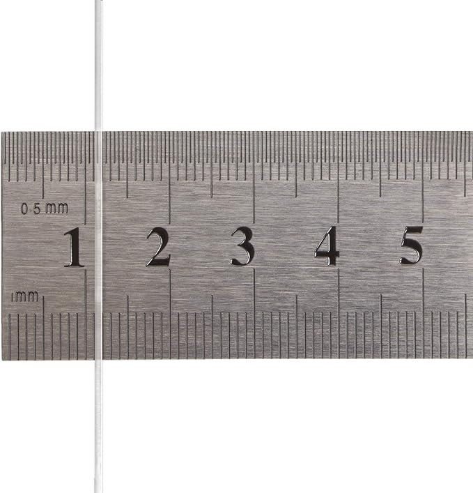 A close-up of a metal ruler with engraved black measurement markings and numbers, shown against a white background.