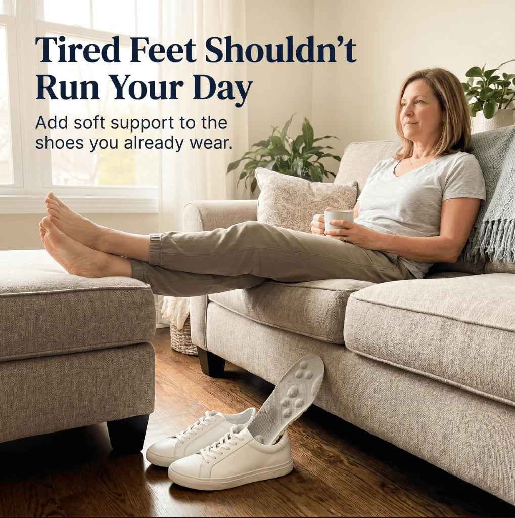 A woman relaxes on a light beige sofa in a bright living room, with her bare feet extended over an ottoman and a white shoe insert visible inside one of her white sneakers on the floor. Text at the top reads, 'Tired Feet Shouldn't Run Your Day' with a subline about adding soft support to shoes you already wear.