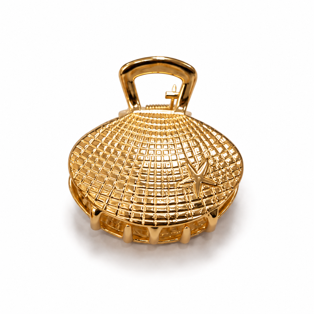 A gold-toned, dome-shaped clutch purse with a textured grid pattern, a top handle, and a small starfish detail on the front, set against a plain white background.
