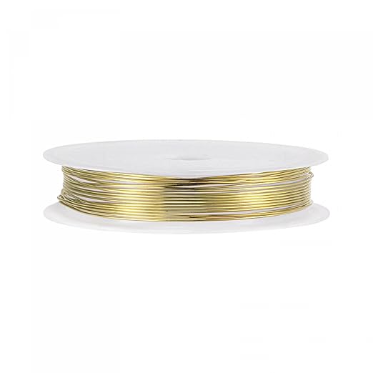 A spool of fine gold-colored 3D printing filament wound on a white plastic core, shown against a plain white background.