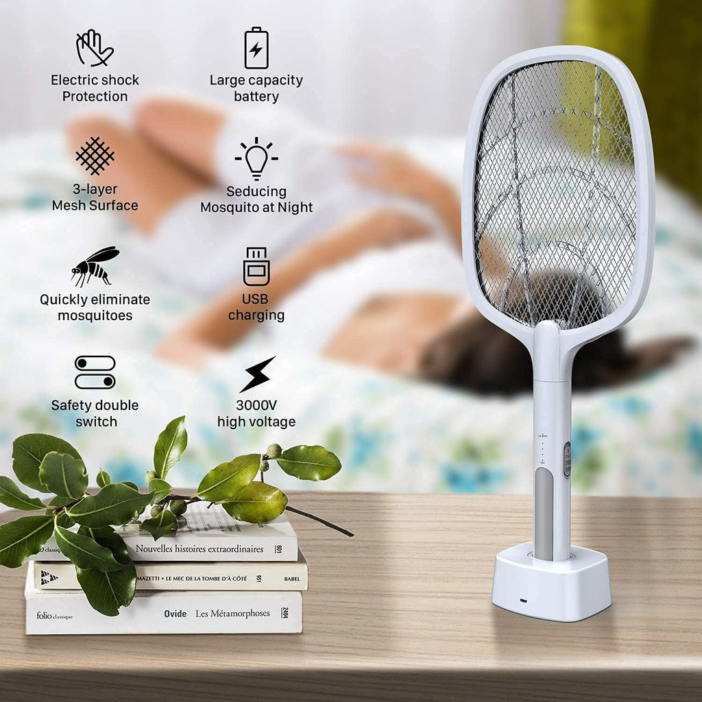 Mosquito racket with features listed on a table with books and plants.