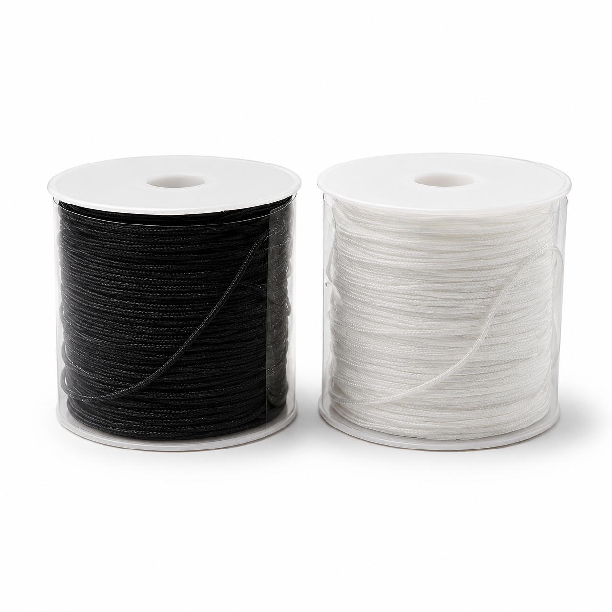 Two spools of braided cord, one black and one white, shown side-by-side on a clean white background.