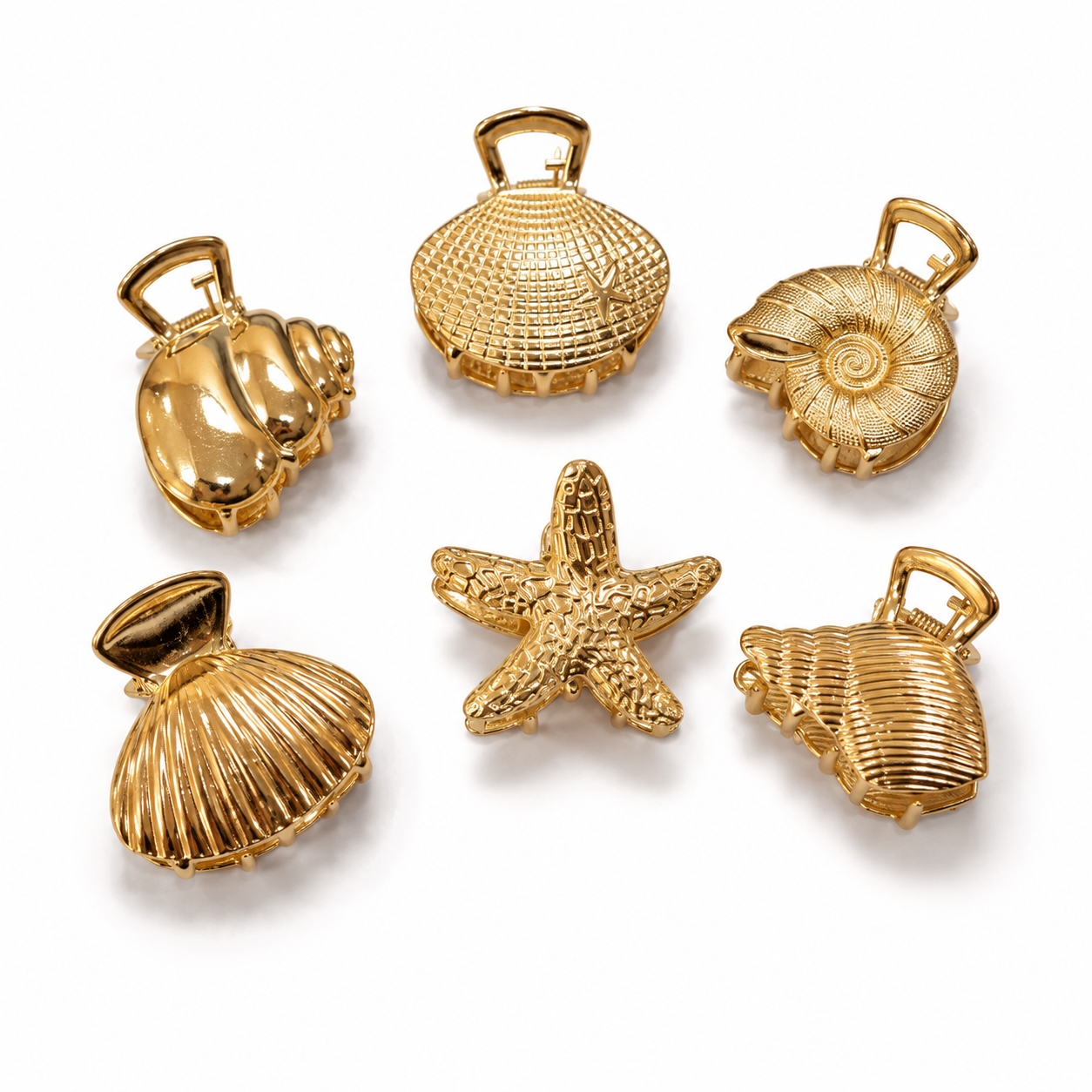 Six gold-toned shell-shaped jewelry charms or pendants arranged on a white background, including a starfish and seashell designs with loop tops.