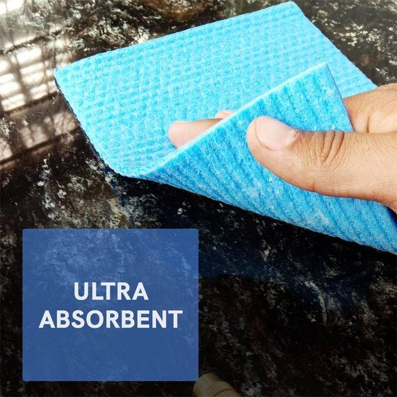 A hand holding a bright blue ultra-absorbent microfiber cleaning cloth over a dark marble countertop, with a blue text box overlay reading 'ULTRA ABSORBENT'.