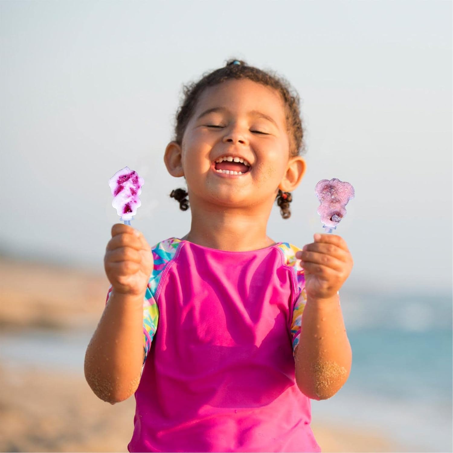 Kids enjoying homemade frozen treats from 7AGAT reusable ice pop molds with assorted colored lids and easy-release design.