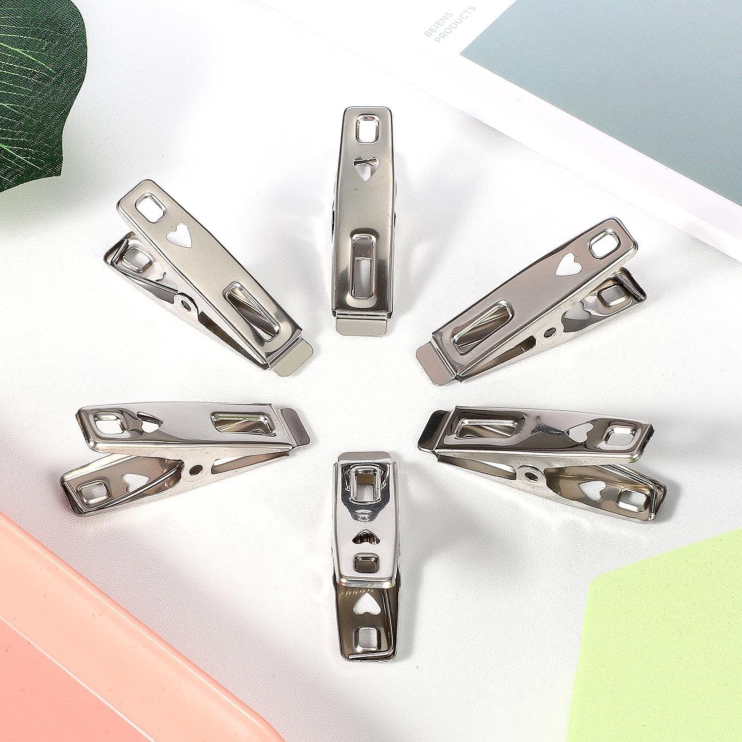 Heavy-duty stainless steel clothespins by 7AGAT, rustproof silver laundry clips for all fabric types and multi-purpose use.