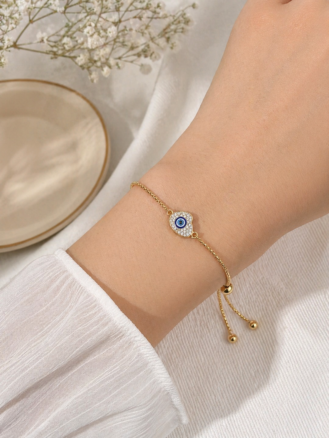 Gold-tone stainless steel evil eye heart charm bracelet with adjustable slider, tarnish-resistant jewelry for daily wear from 7AGAT.