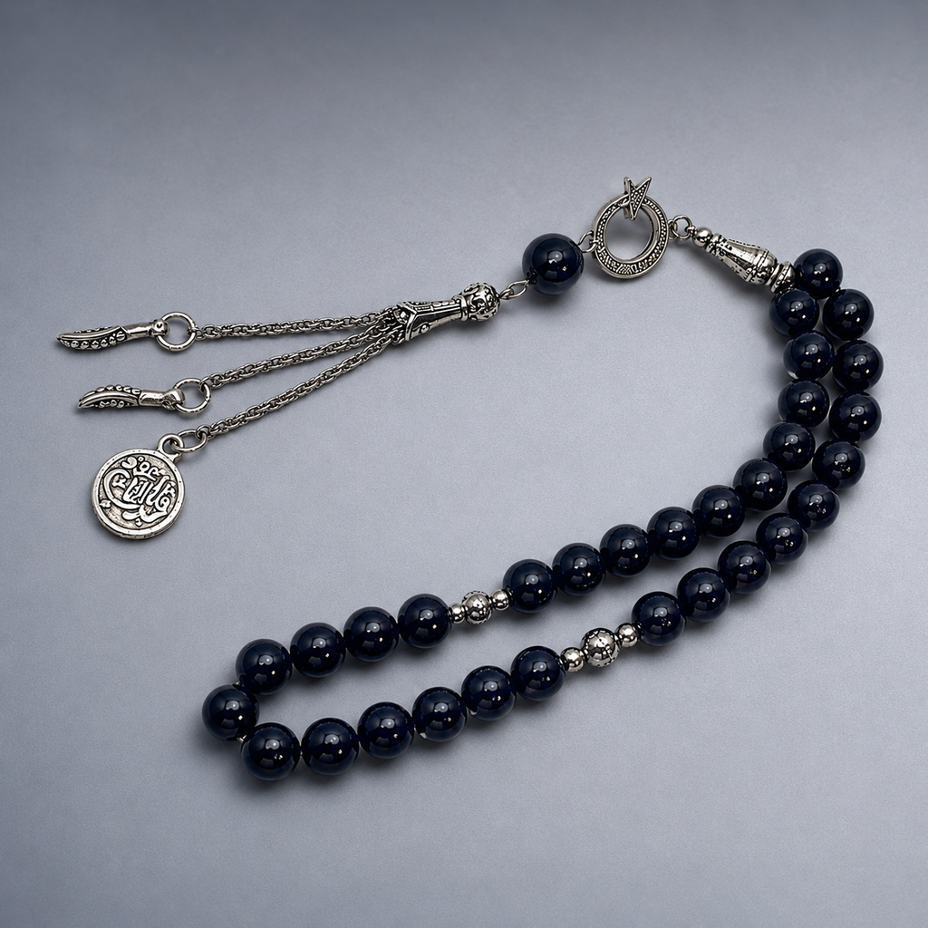 Handmade 33-bead Islamic rosary with 10mm prayer beads from 7AGAT, displayed with a burlap bag for prayer and meditation.