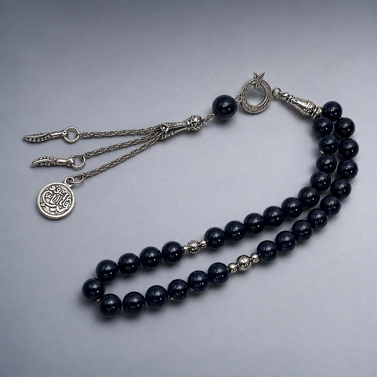 Handmade 33-bead Islamic rosary with 10mm prayer beads from 7AGAT, displayed with a burlap bag for prayer and meditation.