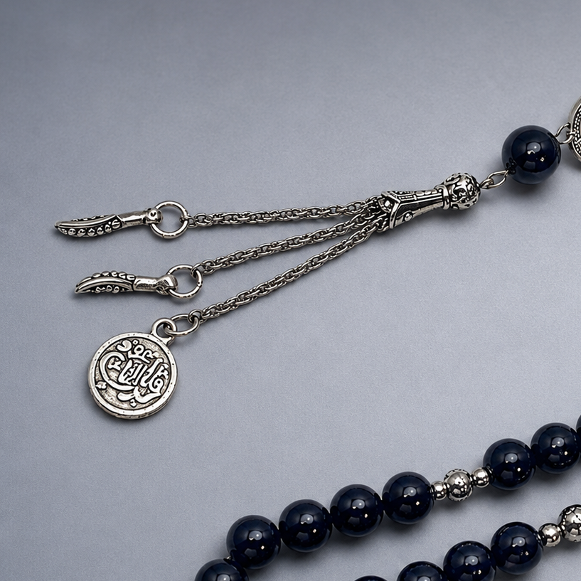 Handmade 33-bead Islamic rosary with 10mm prayer beads by 7AGAT, displayed with burlap bag for prayer and meditation.