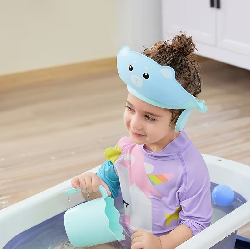 Colorful silicone baby shampoo cap with adjustable strap and earmuff protection, waterproof bath visor for kids' gentle showering.