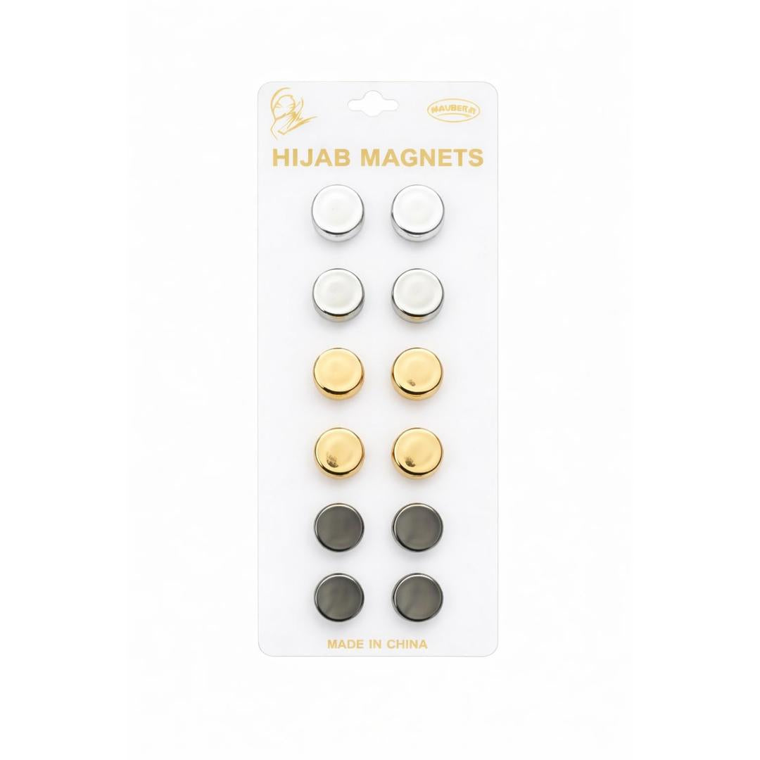 Packaging of hijab magnets with gold, silver, and black colors on a white background.